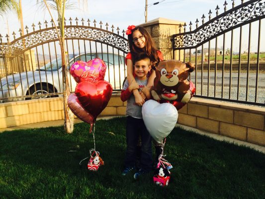 Claidia's Kids holding heart balloons