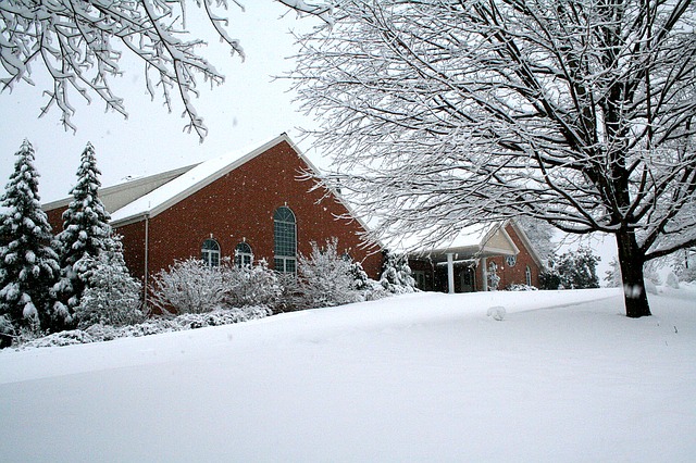 Mennonite Church in park view during the winter with snow. 