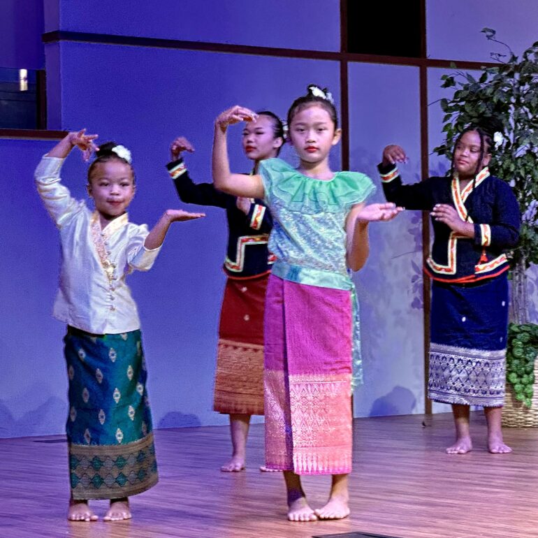 Children on a stage dancing.